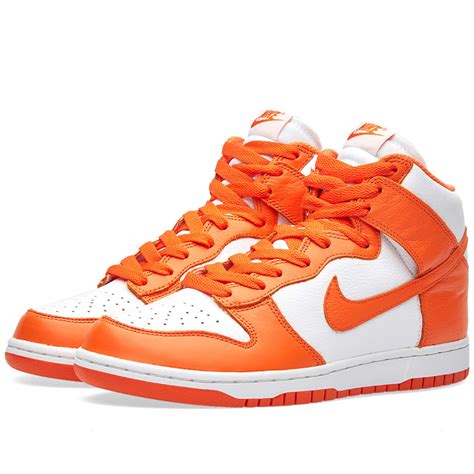 orange and white Nike shoes